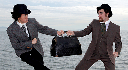 (from l to r) Rami Margron as Passepartout struggles with David Abrams as Fix of the Yard in "Around the World in 80 Days". Photo Credit: Marin Theatre Company.