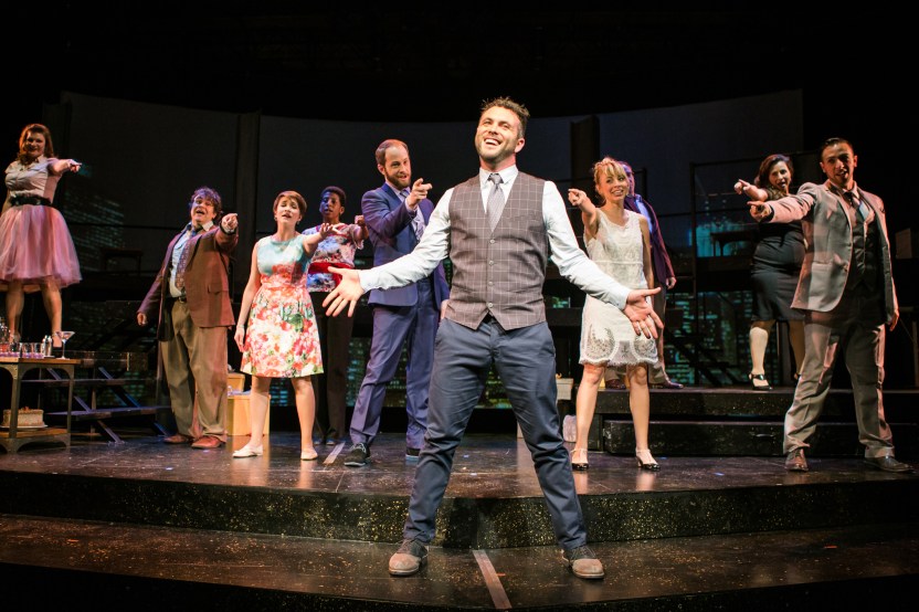 Bobby (Keith Pinto) is put on the spot by the rest of the cast of 